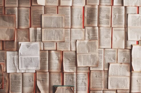 Opened books scattered across the floor
